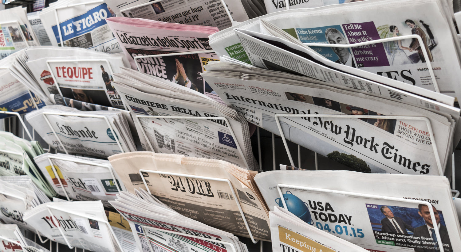 A rack filled with international newspapers in different languages